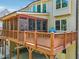 Back exterior of home with a screened-in porch and wooden deck, perfect for outdoor relaxation and entertaining at 1754 Water Springs Way, Dacula, GA 30019