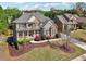 Beautifully landscaped two-story home with manicured lawn, stone facade, and an inviting front porch at 1754 Water Springs Way, Dacula, GA 30019