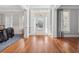 Bright foyer featuring hardwood floors, wainscoting, elegant trim, and a glass-paneled front door at 1754 Water Springs Way, Dacula, GA 30019