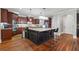 Gourmet kitchen features dark wood cabinets, granite counters, and stainless appliances at 1754 Water Springs Way, Dacula, GA 30019