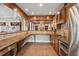 This kitchen is roomy with lots of space for entertaining and features stainless appliances and tile backsplash at 1754 Water Springs Way, Dacula, GA 30019
