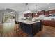 Stunning kitchen with island, pendant lighting, stainless appliances, and hardwood floors at 1754 Water Springs Way, Dacula, GA 30019