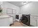 Functional laundry room featuring a front loading washer and dryer at 1754 Water Springs Way, Dacula, GA 30019