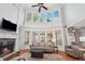 Bright living room boasts soaring ceilings, fireplace, and abundant windows overlooking the backyard at 1754 Water Springs Way, Dacula, GA 30019