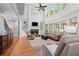 Inviting living room with fireplace, built-ins, hardwood floors, and large windows, creating a warm ambiance at 1754 Water Springs Way, Dacula, GA 30019