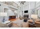 Spacious living room featuring a soaring ceiling, fireplace, hardwood floors, and an open staircase at 1754 Water Springs Way, Dacula, GA 30019