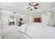 Spacious main bedroom featuring fireplace, ceiling fan, sitting area, and ensuite bathroom at 1754 Water Springs Way, Dacula, GA 30019