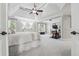 Spacious main bedroom with sitting area, fireplace, ceiling fan, and exercise equipment at 1754 Water Springs Way, Dacula, GA 30019