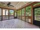 Serene screened-in porch with wood flooring and views of lush greenery at 1754 Water Springs Way, Dacula, GA 30019