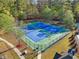 Aerial view of two tennis courts within a fenced in area in an exclusive community at 1754 Water Springs Way, Dacula, GA 30019