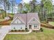Aerial view of the home showing the roof, and the surrounding fenced yard with large trees and a long driveway at 505 Bryson Lake Cir, Douglasville, GA 30134