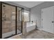 Modern bathroom featuring a glass shower, soaking tub, and tile flooring at 505 Bryson Lake Cir, Douglasville, GA 30134