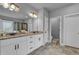 Bathroom featuring double sinks, granite countertops, a large mirror, and modern fixtures, creating a luxurious space at 505 Bryson Lake Cir, Douglasville, GA 30134