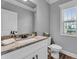 Powder room featuring granite countertops, a white vanity, and modern fixtures, offering a blend of style and convenience at 505 Bryson Lake Cir, Douglasville, GA 30134