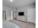 Bright bedroom with dresser, TV, and neutral color scheme at 505 Bryson Lake Cir, Douglasville, GA 30134