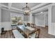 Bright dining area with an inviting long table, a bench, a decorative rug, and large windows for lots of light at 505 Bryson Lake Cir, Douglasville, GA 30134
