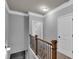 Upstairs hallway with natural light, neutral decor, and detailed trim at 505 Bryson Lake Cir, Douglasville, GA 30134