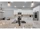 Open kitchen with granite countertops, stainless steel appliances, white cabinets, recessed lighting, and a modern sink at 505 Bryson Lake Cir, Douglasville, GA 30134