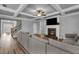 Open-concept living room with a fireplace, large sectional couch, and hardwood floors, creating a welcoming atmosphere at 505 Bryson Lake Cir, Douglasville, GA 30134