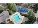 Aerial view showcasing the sparkling community pool and tennis courts, surrounded by lush greenery and residences at 6820 Glenridge Dr # C, Sandy Springs, GA 30328