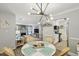 Bright dining area with modern chandelier, table setting, and seamless flow into living spaces at 6820 Glenridge Dr # C, Sandy Springs, GA 30328