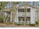Charming exterior of a multi-level home with private balconies, complemented by natural surroundings and mature trees at 6820 Glenridge Dr # C, Sandy Springs, GA 30328