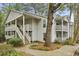Multi-level condo exterior highlighting balconies, stairs, and natural landscaping at 6820 Glenridge Dr # C, Sandy Springs, GA 30328