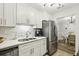 Clean kitchen with stainless steel appliances, white cabinets and marble backsplash at 6820 Glenridge Dr # C, Sandy Springs, GA 30328