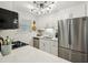 Modern kitchen featuring stainless steel appliances, white cabinets, and ample counter space at 6820 Glenridge Dr # C, Sandy Springs, GA 30328