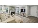 Bright living room with fireplace, large TV, modern decor, and a comfortable, inviting atmosphere at 6820 Glenridge Dr # C, Sandy Springs, GA 30328