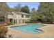 Exterior shot of a well-maintained pool surrounded by lush greenery, providing a tranquil escape at 6820 Glenridge Dr # C, Sandy Springs, GA 30328