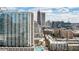 Stunning aerial view of a modern high-rise with a rooftop pool and lush landscaping at 860 Peachtree Ne St # 2716, Atlanta, GA 30308