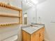 Bathroom with modern granite vanity, cabinet storage, and wooden storage shelf at 860 Peachtree Ne St # 2716, Atlanta, GA 30308