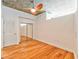 Clean bedroom features a sliding door closet, ceiling fan, and hardwood floors at 860 Peachtree Ne St # 2716, Atlanta, GA 30308