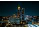 Nighttime cityscape view featuring illuminated skyscrapers against a dark sky, showcasing urban living at 860 Peachtree Ne St # 2716, Atlanta, GA 30308