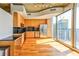Modern kitchen featuring stainless steel appliances, wood cabinets, and a black backsplash, with an adjacent outdoor view at 860 Peachtree Ne St # 2716, Atlanta, GA 30308