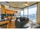 Open-concept living area with a modern kitchen, comfortable seating, and panoramic city views at 860 Peachtree Ne St # 2716, Atlanta, GA 30308