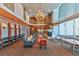 Inviting lobby area featuring comfortable seating, fireplace, high ceilings, and a well-lit workspace at 860 Peachtree Ne St # 2716, Atlanta, GA 30308