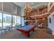 Two-story lounge area with pool table, fireplace, and floor to ceiling windows at 860 Peachtree Ne St # 2716, Atlanta, GA 30308