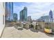 An outdoor kitchen area features stainless steel grills with city views at 860 Peachtree Ne St # 2716, Atlanta, GA 30308