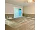 Spacious bedroom with carpet flooring, neutral paint, and sliding glass door to backyard at 927 Pine Oak Trl, Austell, GA 30168