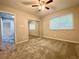 Bedroom featuring a mirrored closet, ceiling fan, and a window at 927 Pine Oak Trl, Austell, GA 30168
