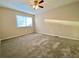 Spacious bedroom featuring a ceiling fan, window and neutral carpeting at 927 Pine Oak Trl, Austell, GA 30168