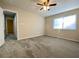 Spacious bedroom featuring a ceiling fan, a window and neutral carpeting at 927 Pine Oak Trl, Austell, GA 30168