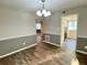 Dining room with hardwood floors, two-tone paint, and chandelier lighting at 927 Pine Oak Trl, Austell, GA 30168