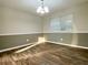 Dining room featuring wood floors and a modern light fixture at 927 Pine Oak Trl, Austell, GA 30168