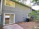 The exterior of the home features a walk-out patio and mature landscaping at 927 Pine Oak Trl, Austell, GA 30168