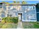 Two-story exterior of townhouse with a walkway, bushes, and windows at 927 Pine Oak Trl, Austell, GA 30168