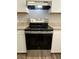 Stainless steel GE range with flat top and stainless vent hood at 927 Pine Oak Trl, Austell, GA 30168