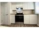 Kitchen with updated white cabinets, granite countertops, and stainless steel appliances at 927 Pine Oak Trl, Austell, GA 30168